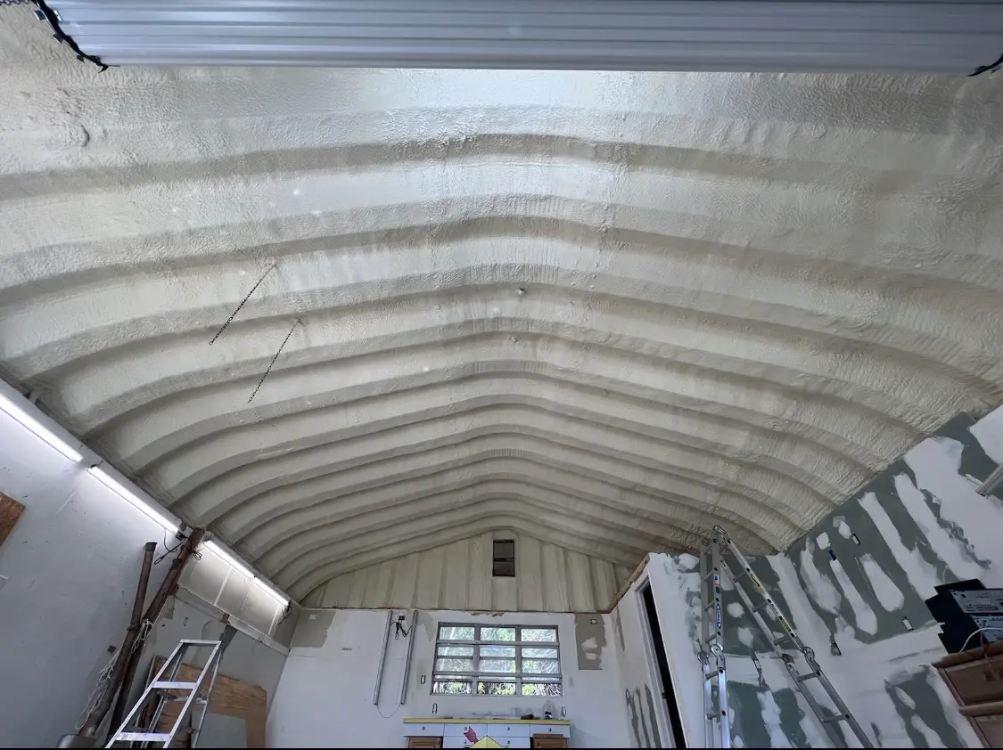 Spray polyurethane foam applied to the underside of a metal roof deck in Gloucester